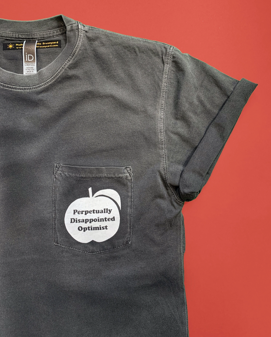 Perpetually Disappointed Optimist Pocket Unisex Tee